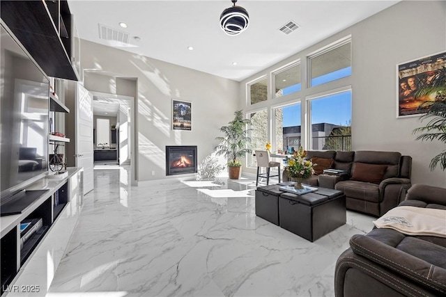 living room with a towering ceiling