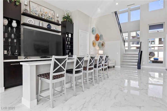 kitchen featuring a breakfast bar and a high ceiling