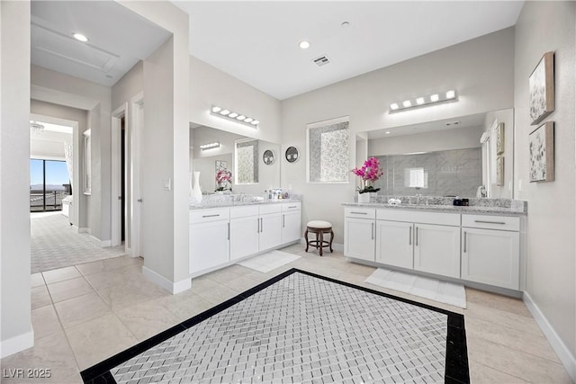 bathroom featuring walk in shower and vanity