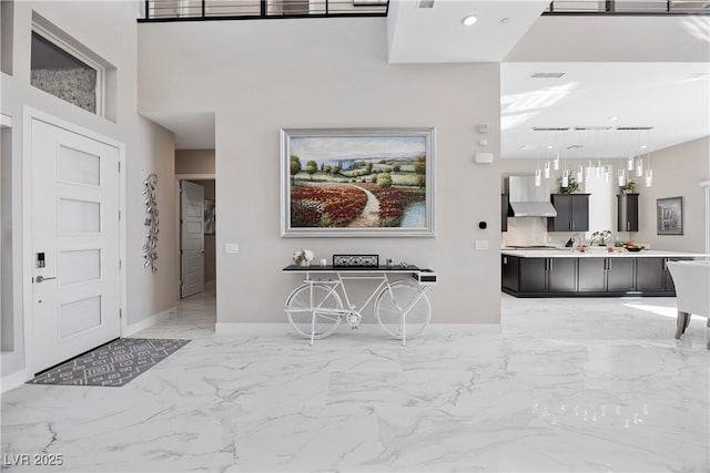 foyer entrance with a high ceiling