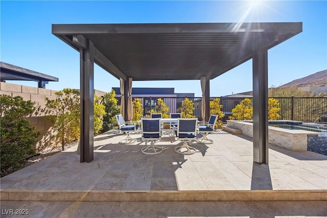 view of patio / terrace featuring an in ground hot tub and a mountain view