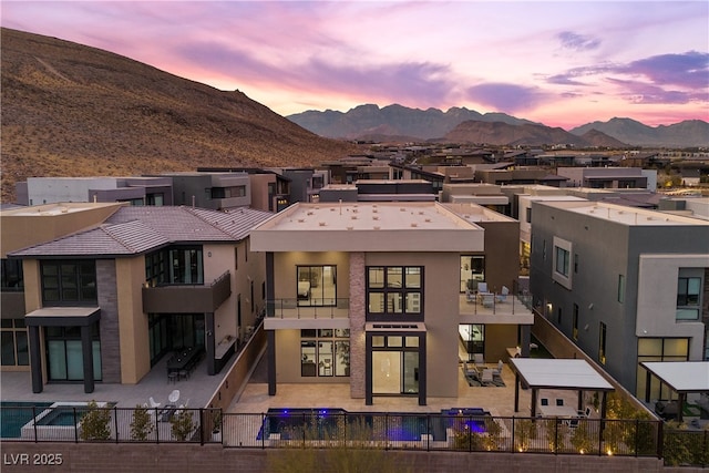 back house at dusk featuring a mountain view