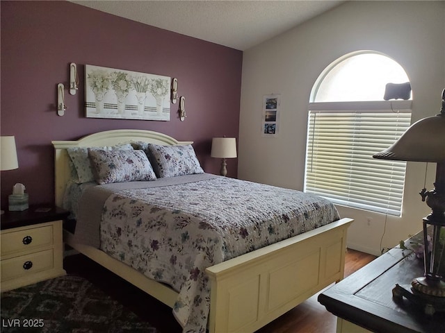 bedroom featuring lofted ceiling and wood-type flooring