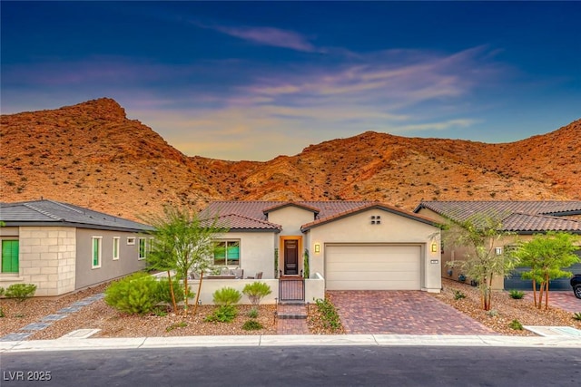 view of front of house with a garage and a mountain view