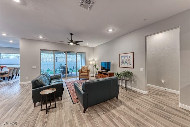 living room featuring ceiling fan and light wood-type flooring