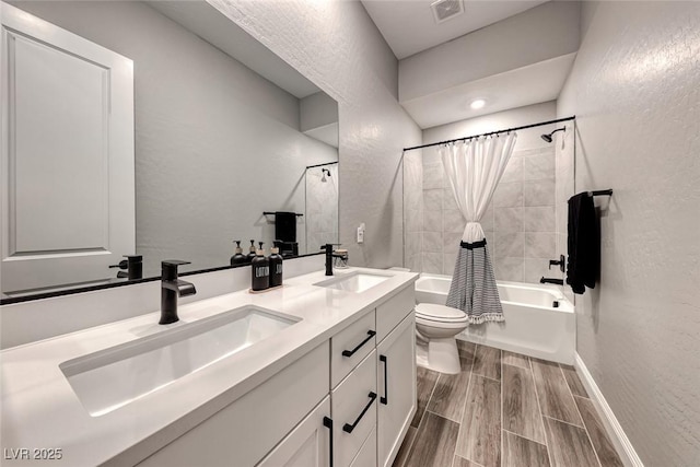 full bathroom with vanity, toilet, and shower / bath combo