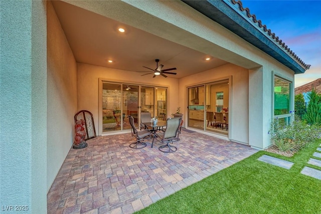 patio terrace at dusk with ceiling fan