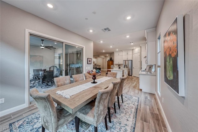 dining room featuring sink and light hardwood / wood-style floors