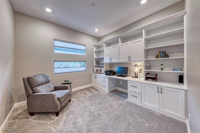 carpeted home office with built in desk