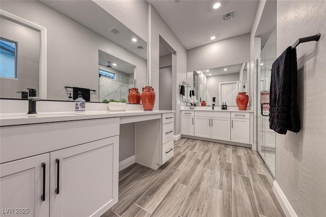 bathroom with vanity and an enclosed shower