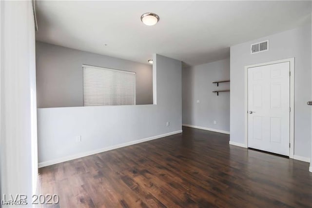 unfurnished room featuring dark hardwood / wood-style floors