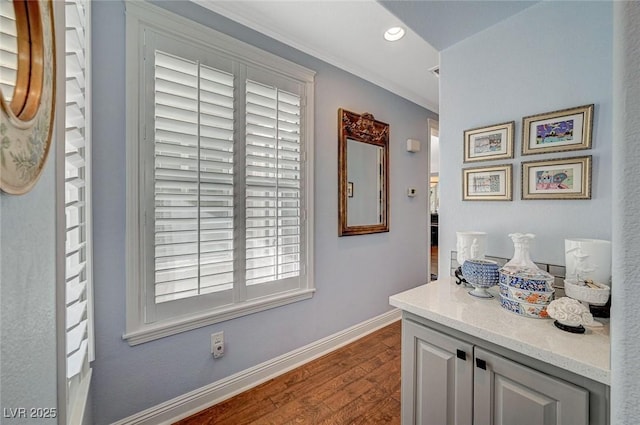 hallway with dark wood-type flooring and crown molding