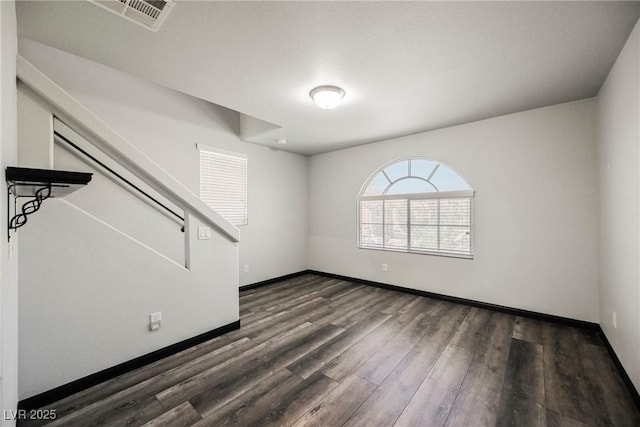 empty room with dark hardwood / wood-style floors