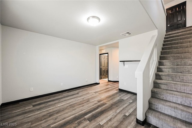 stairway with hardwood / wood-style floors