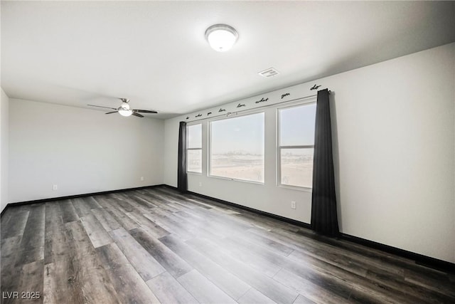 spare room featuring hardwood / wood-style floors and ceiling fan