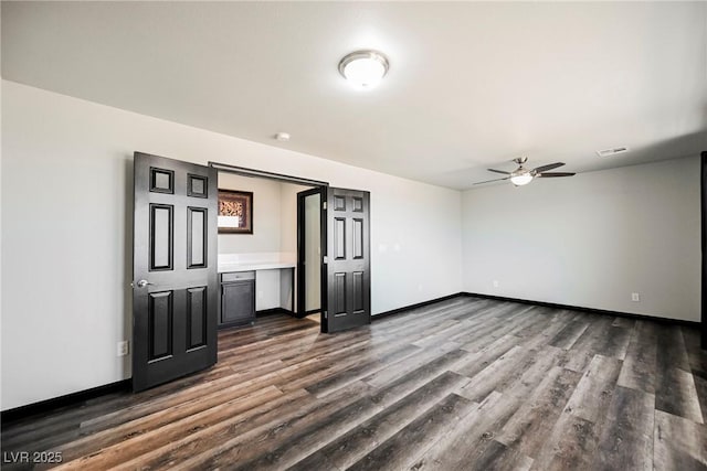 spare room featuring ceiling fan and dark hardwood / wood-style flooring