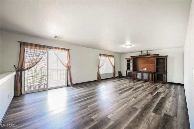 unfurnished living room with dark hardwood / wood-style flooring