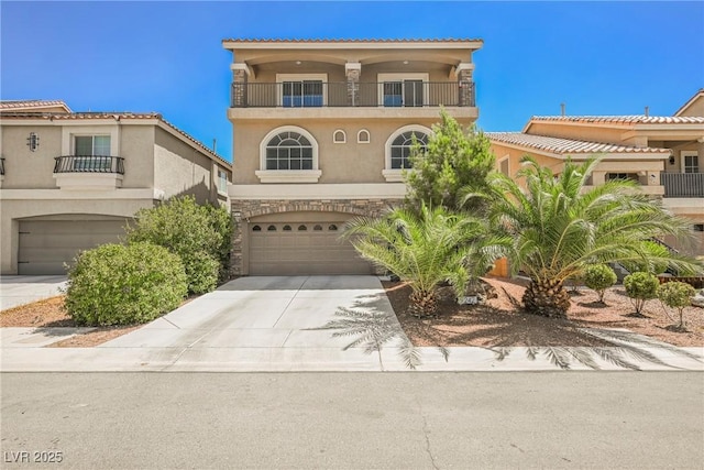 mediterranean / spanish-style home featuring a garage and a balcony