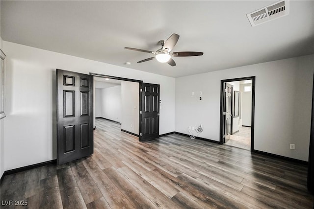 empty room with wood-type flooring and ceiling fan