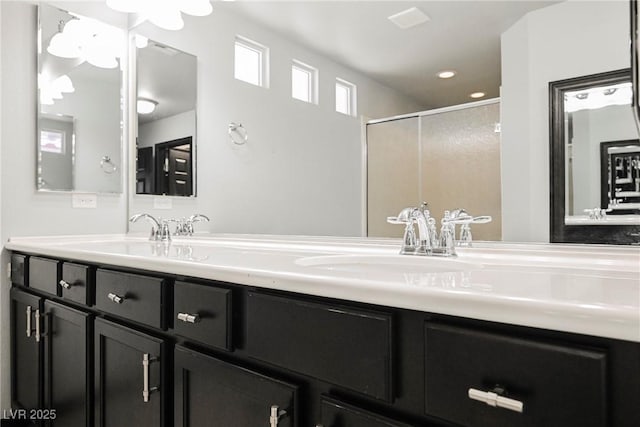 bathroom with vanity and a shower with shower door