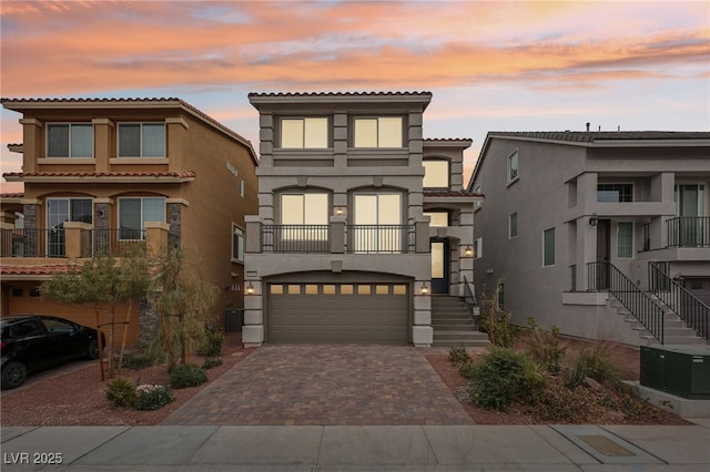 view of front of property featuring a garage and central AC unit