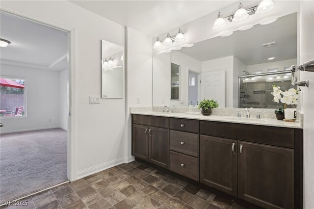 bathroom with vanity and a shower with door