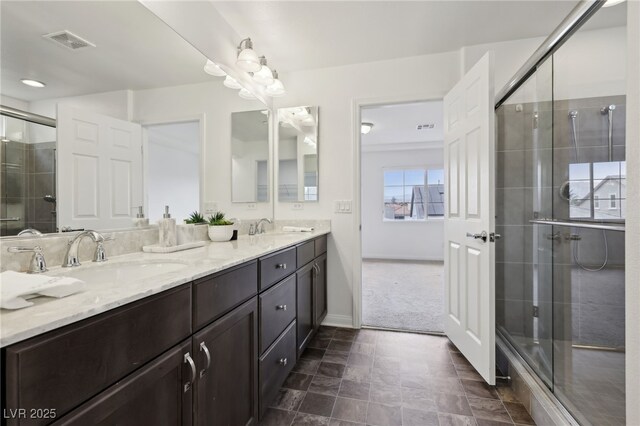 bathroom featuring vanity and a shower with door