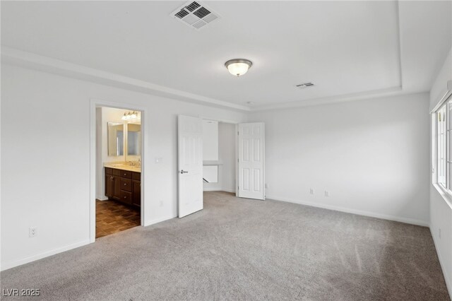 unfurnished bedroom featuring sink, carpet floors, and connected bathroom