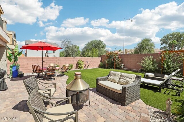 view of patio / terrace with an outdoor living space with a fire pit