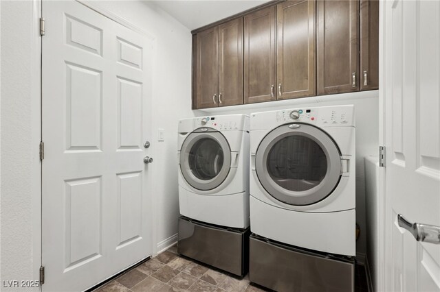 laundry area featuring independent washer and dryer and cabinets