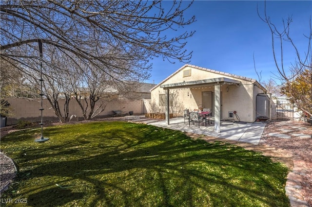 back of house featuring a yard and a patio