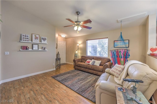 living room with ceiling fan, wood-type flooring, and vaulted ceiling