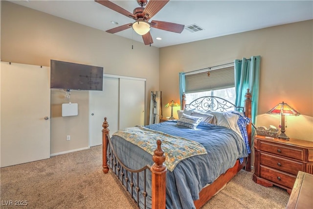 bedroom with light carpet, a closet, and ceiling fan