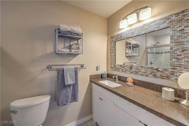 bathroom featuring vanity, toilet, and walk in shower