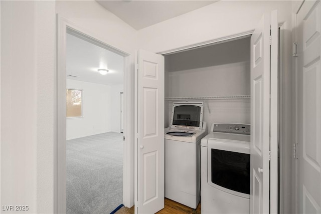 laundry area featuring washer and dryer and light colored carpet