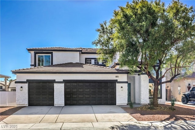 view of front facade with a garage, stone siding, driveway, and stucco siding