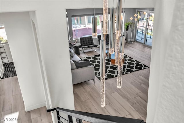 dining area with wood tiled floor, a healthy amount of sunlight, and baseboards