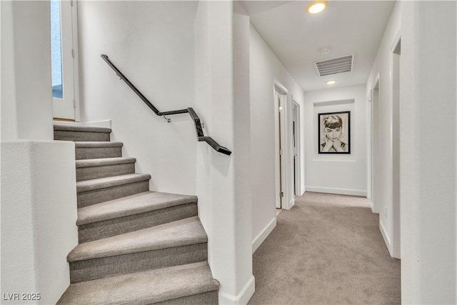 stairway with recessed lighting, carpet flooring, visible vents, and baseboards