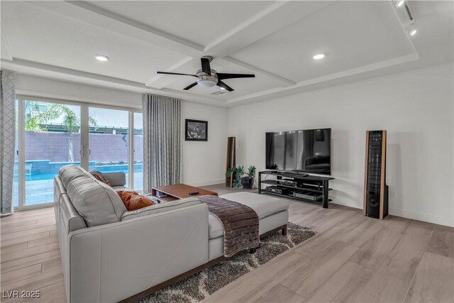 living room with coffered ceiling, beamed ceiling, light hardwood / wood-style floors, and ceiling fan