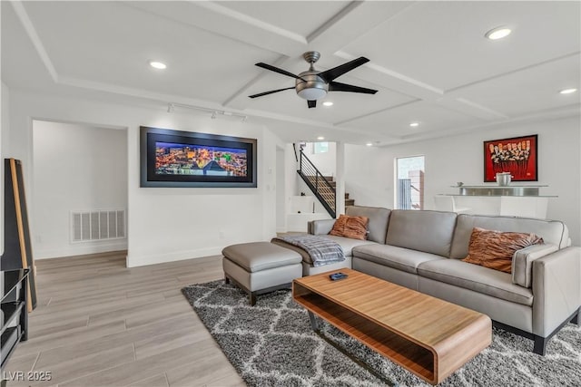 living room with ceiling fan and light wood-type flooring