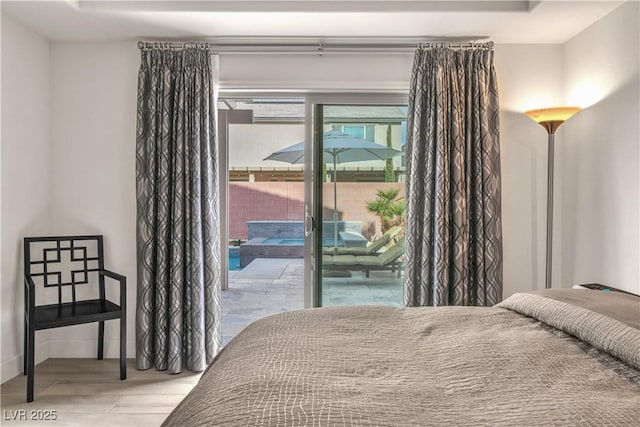 bedroom featuring light hardwood / wood-style flooring and access to outside