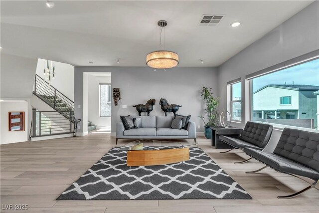 living room with a wealth of natural light and light hardwood / wood-style flooring