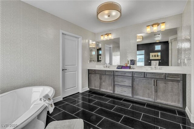 bathroom featuring tile patterned flooring, vanity, and a washtub