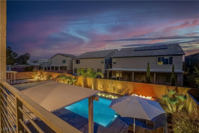 view of pool at dusk