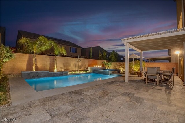 view of pool featuring a pool with connected hot tub, a patio area, and a fenced backyard