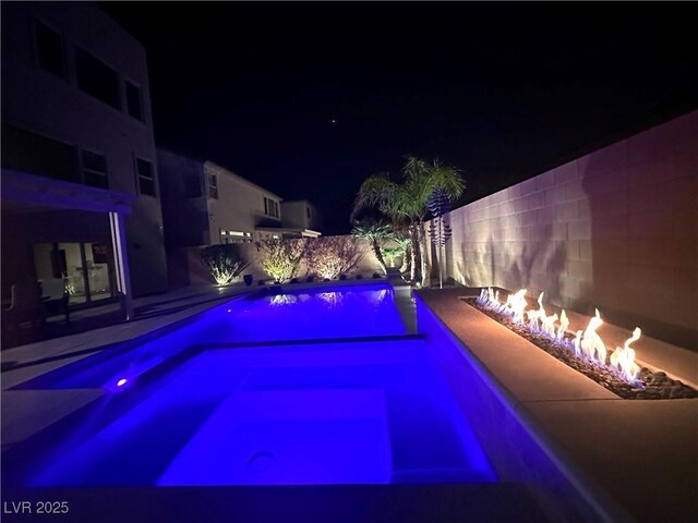 pool at twilight with a fire pit, a patio, a fenced backyard, and a fenced in pool