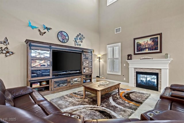 living room with light tile patterned floors and a towering ceiling