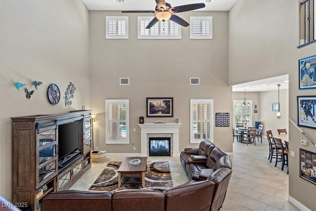 living room featuring ceiling fan and a fireplace