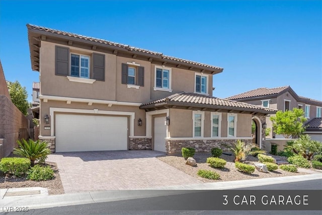 2920 Josephine Dr, Henderson, NV 89044 - view of front facade with stone siding, stucco siding, a garage, driveway, and a tiled roof