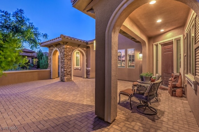 view of patio terrace at dusk